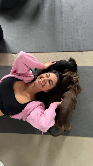 Yoga with puppies and a smiling woman