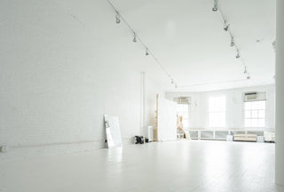 Spacious bright yoga studio in Manhattan with white walls and ceiling, ideal for puppy yoga events and relaxing sessions.